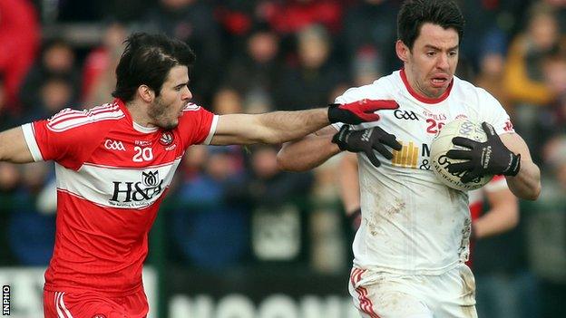 Derry defender Karl McKaigue challenges Tyrone's Mattie Donnelly in the McKenna Cup clash