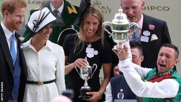 Frankie Dettori collects his trophy at Ascot from the Duke and Duchess of Sussex