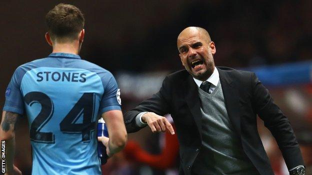 Man City defender John Stones and manager Pep Guardiola