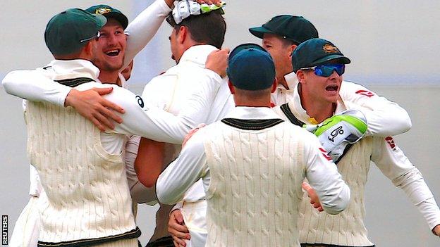 Australia players celebrate taking the wicket of England captain Joe Root during the second Test at Adelaide