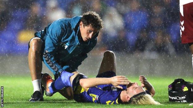 Nathan Young-Coombes injured his knee just before half-time of Wimbledon's defeat by Northampton