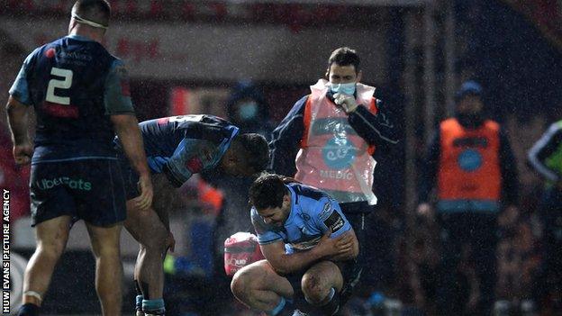 Cardiff Blues scrum-half Tomos Williams in discomfort after suffering injury against Scarlets