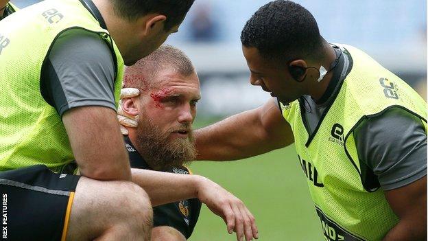 A bloodied Brad Shields receives treatment