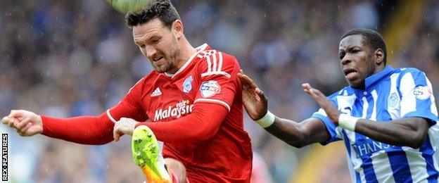 Cardiff's Sean Morrison (left) challenges Lucas Joao of Sheffield Wednesday