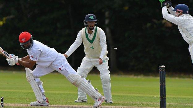 Hong Kong opener Ninad Shah escapes a stumping attempt by Niall O'Brien