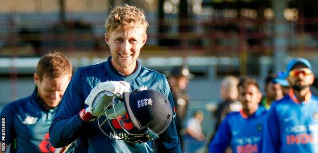 Joe Root walks off smiling