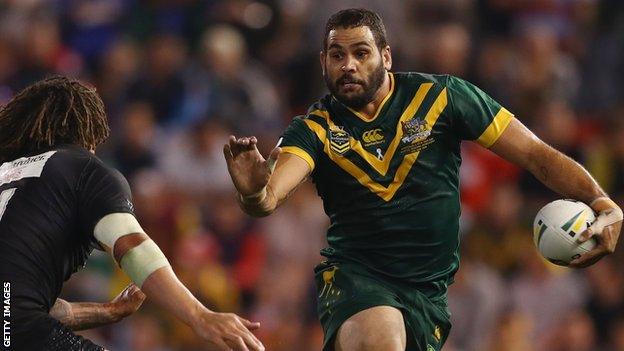 Greg Inglis fends away Kevin Proctor while playing for Australia v New Zealand