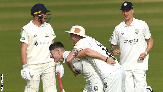 Durham bowler Matty Potts celebrates with Ben Stokes after taking the wicket of Glamorgan's Andrew Salter