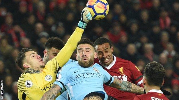 Liverpool and Man City players compete for the ball