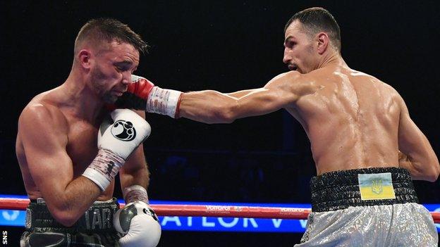 Josh Taylor takes a shot from Viktor Postol