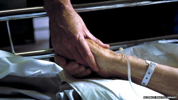 Nurse holds patients hand