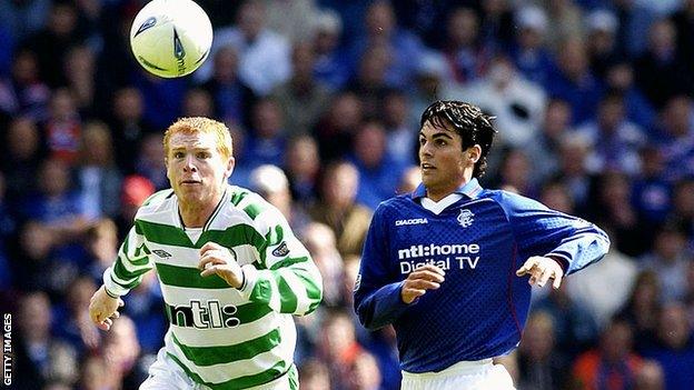 Arteta (right) challenges Neil Lennon for the ball