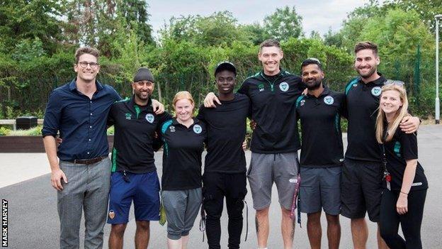 Bukayo Saka (fourth from left) with staff from Greenford High School, including PE teacher Mark Harvey (fourth from right)