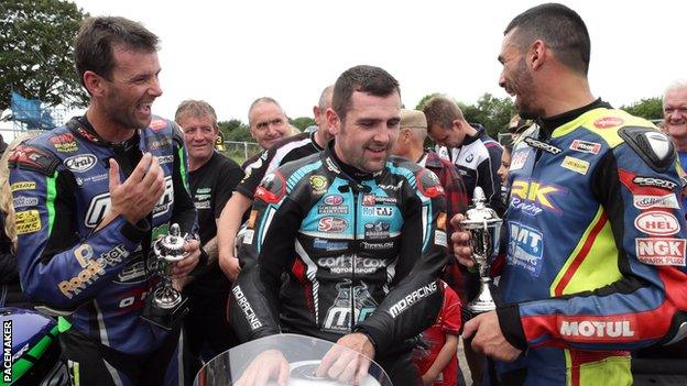 Michael Dunlop is flanked by Michael Sweeney and Derek Sheils after winning the feature Race of Legends event for an eighth time in a row in 2019