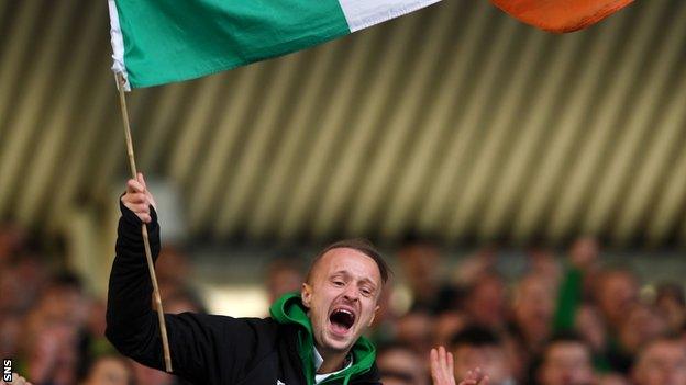 Celtic striker Leigh Griffiths celebrates in the Ibrox stand