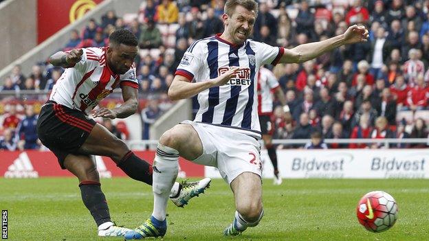 Jermain Defoe gets a shot away under pressure from Gareth McAuley