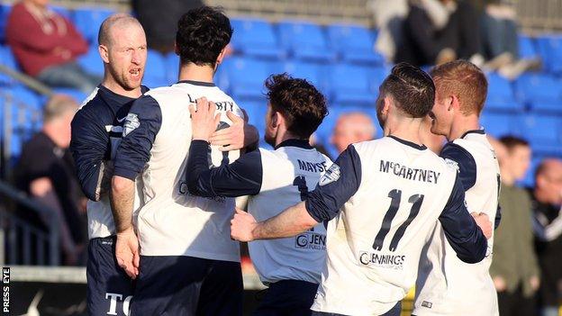 Ballinamallard players run to congratulate Stephen O'Flynn after the striker scored the opening goal