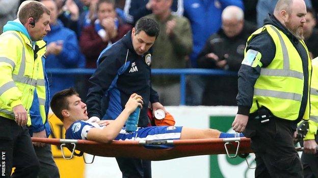 Brad Lyons is stretchered off after sustaining his injuries in the league win over Linfield