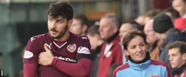 Hearts' Callum Paterson nurses his injured shoulder