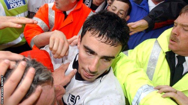 Leon Britton is mobbed by fans after helping Swansea beat Hull City in 2003 to preserve their Football League status