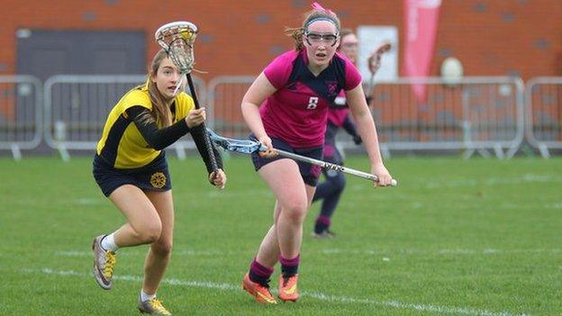 Girls taking part in a lacrosse match