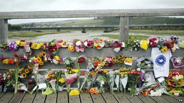 Floral tributes on a bridge near the A27