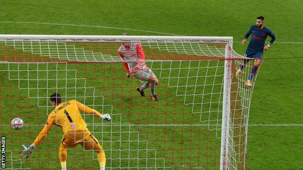 Yannick Carrasco of Atletico Madrid scores against Red Bull Salzburg