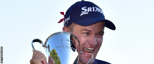 Russell Knox celebrates with the Travelers Championship trophy