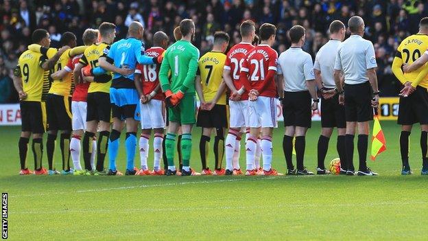 Watford and Manchester United players line up in the centre circle before Saturday's game