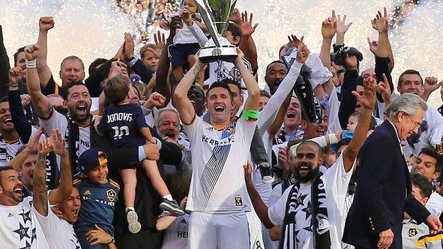 LA Galaxy's Robbie Keane lifts the 2014 MLS Cup