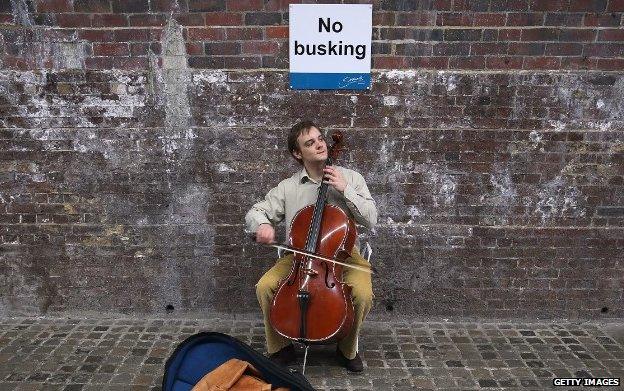 'No busking' sign