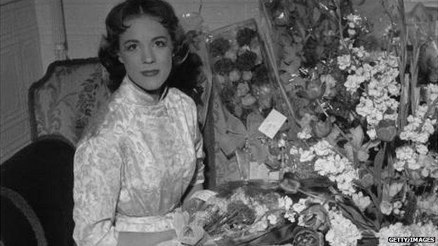 'My Fair Lady' Julie Andrews surrounded by flowers in her dressing room at the Drury Lane Theatre London.