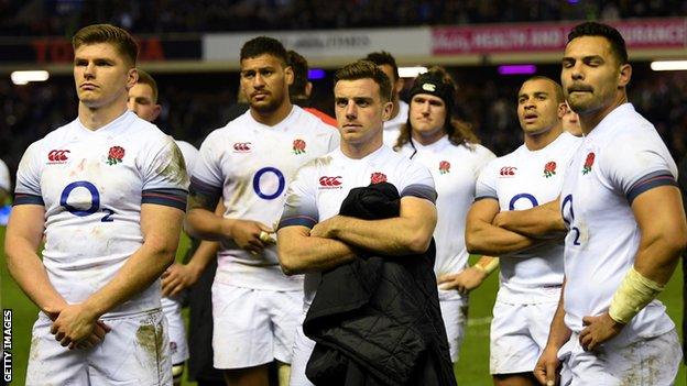 England players look on as Scotland lift the Calcutta Cup