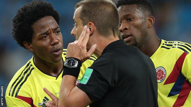 Carlos Sanchez pleads with the referee