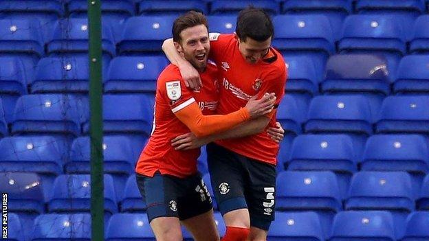 Luton left-back Dan Potts celebrated his first goal of the season with the help of Jordan Clark