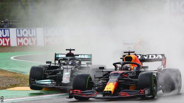 Lewis Hamilton and Max Verstappen race each other on track at Imola in the rain