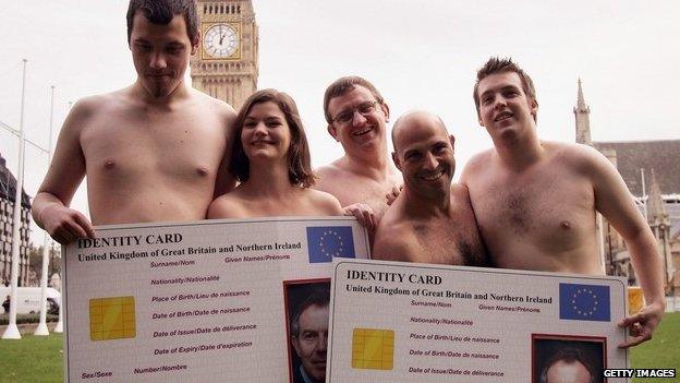 No2ID campaigners holding up giant ID cards while naked