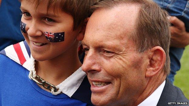 Australian Prime Minister Tony Abbott with a young boy on Australia Day