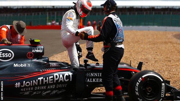 Jenson Button of Great Britain and McLaren Honda climbs out of his car after retiring in the Formula One Grand Prix of Great Britain at Silverstone Circuit on July 5, 2015