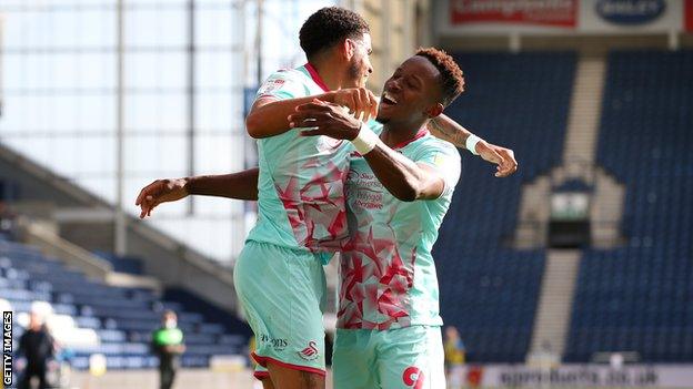 Jamal Lowe celebrates fellow Swansea league debutant Morgan Gibbs-White's winner at Preston on the opening day of the season