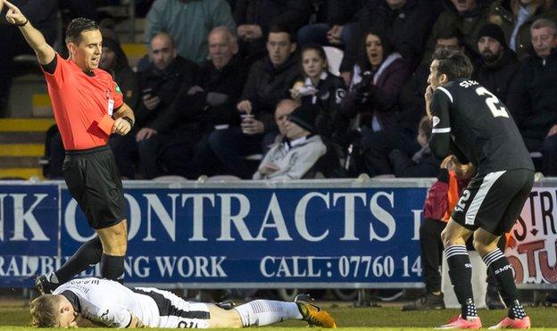 Referee Andrew Dallas and St Mirren defender Stelios Demetriou