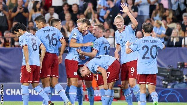 Man City celebrating a goal against Sevilla