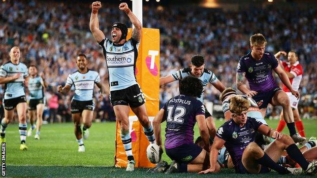 Michael Ennis of the Sharks celebrates the try to Andrew Fifita