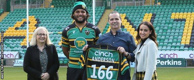 Martin Faulkner (holding the shirt), with his wife Tracey (left), daughter Amelia (right) and Saints player Lewis Ludlam