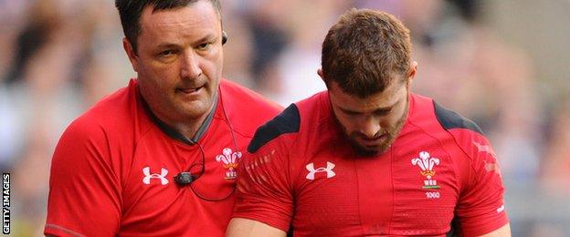 Leigh Halfpenny is led off the field with a dislocated shoulder during Wales' 2014 Six Nations match with England