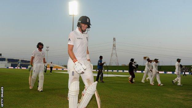 Joe Root walks off after bad light ends the Test