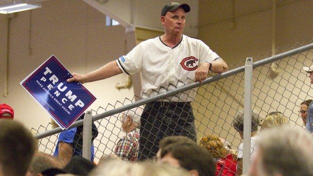 Trump fan holding pro Trump poster