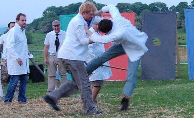 Two men compete at shin-kicking