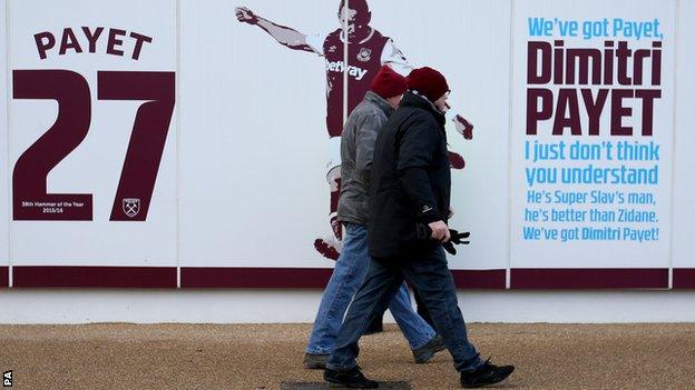 West Ham United fans outside London Stadium near Dimitri Payet signage