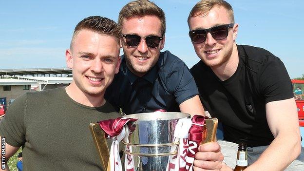 Nicky Adams (right) celebrates the League Two title with teammates